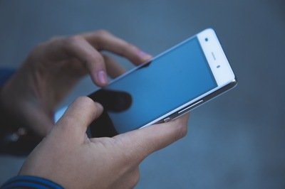mobile HRMS app - person holding phone mobile HRMS app - person holding phone